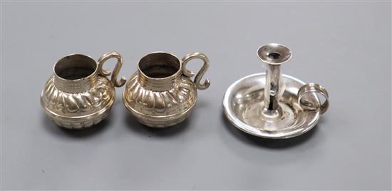 A pair of late Victorian Britannia standard silver miniature mugs and a late Victorian miniature silver chamberstick.